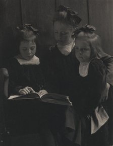 Three young girls reading a book, c1900. Creator: Gertrude Kasebier.