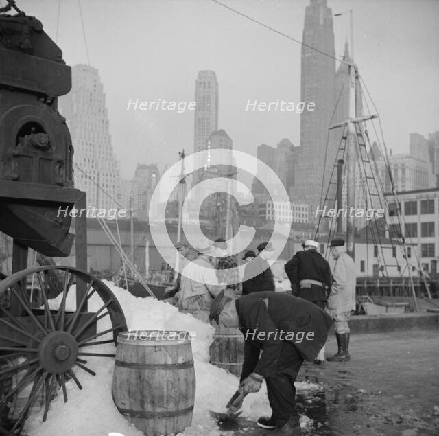 Icing barrels of fish at the Fulton fish market, New York, 1943. Creator: Gordon Parks.