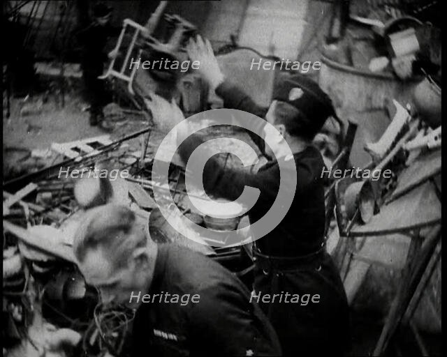 Scrap Metal Being Thrown into a Pile, 1936. Creator: British Pathe Ltd.