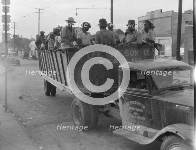 Cotton hoers from Memphis bound for the Wilson Plantation in Arkansas, forty-three miles away, 1937. Creator: Dorothea Lange.