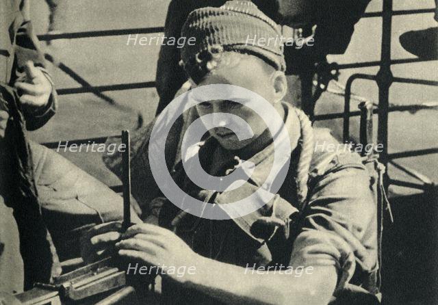 Royal Marine checking his machine gun, World War II, c1939-c1943 (1944). Creator: Unknown.