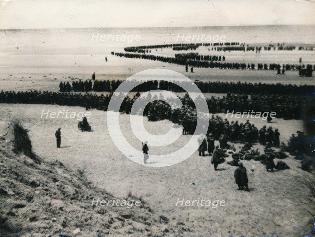 British and French troops wait on the dunes to be evacuated, Dunkirk, 1940. Artist: Unknown