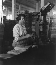Wooden Box Industry: young woman working at machine, c1910. Creator: Frances Benjamin Johnston.