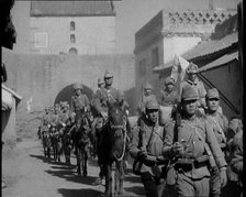 Japanese Soldiers Marching and Riding On Horseback Under an Arch and Through a Street..., 1937. Creator: British Pathe Ltd.