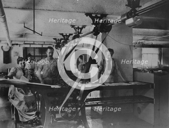 Workers in the postage stamp gumming and drying room in the Stamp Division..., ca 1895. Creator: Frances Benjamin Johnston.