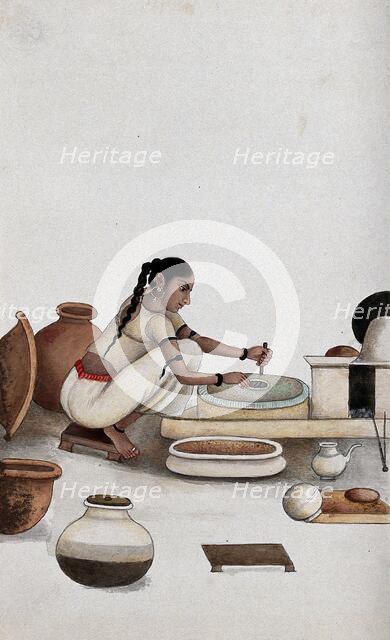 Delhi: a woman grinding grain into flour, (between 1800 and 1899?). Creator: Unknown.