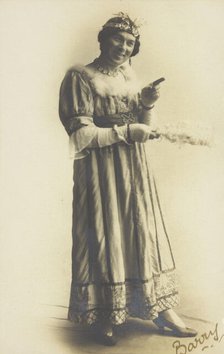 A man in drag, holding a feather, performing in the play 'A country girl', 1920. Creator: Unknown.