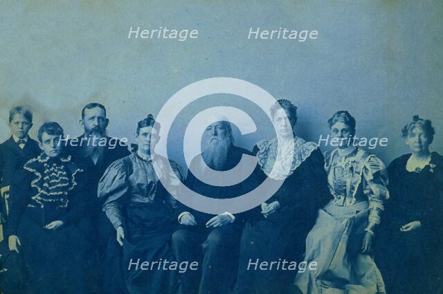 Frances Benjamin Johnston posed with seven members of her family, in her Washington..., 1896. Creator: Frances Benjamin Johnston.