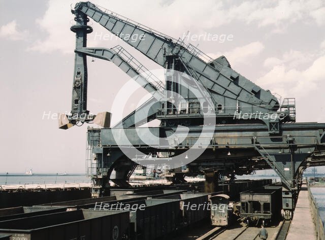 Unloading a lake freighter at the Pennsylvania Railroad iron ore docks...Cleveland, Ohio, 1943. Creator: Jack Delano.