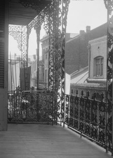 Upper level balconies with wrought iron on St. Peter Street, New Orleans, between 1920 and 1926. Creator: Arnold Genthe.