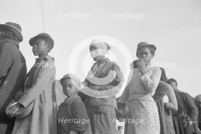 Negroes in the lineup for food at meal time in the camp for flood..., Forrest City, Arkansas, 1937. Creator: Walker Evans.