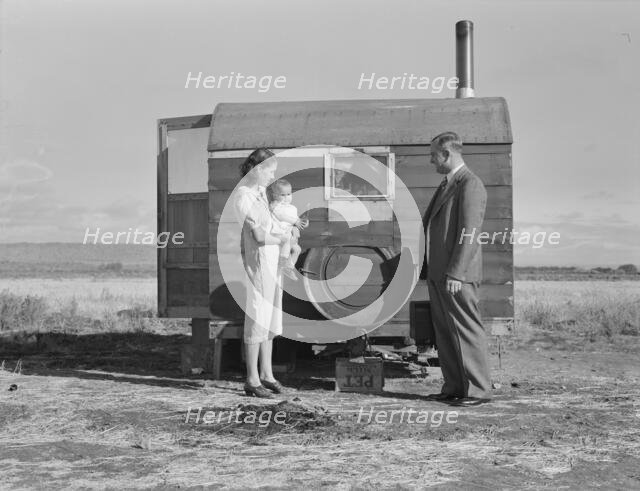 The doctor reassures the mother after having seen the sick..., Merrill, Klamath County, Oregon, 1939 Creator: Dorothea Lange.