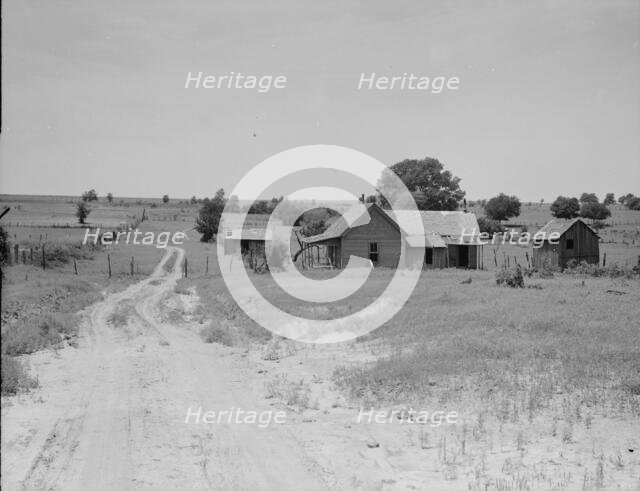 Worn-out land and abandoned cabins near Newport, Oklahoma, 1937. Creator: Dorothea Lange.