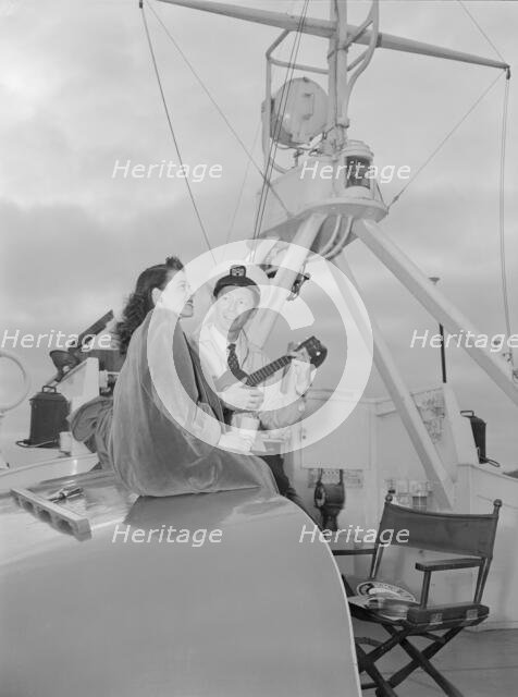 Portrait of Frank Raye and Betty Brewer, Ukelele Lady (yacht), Hudson River, N.Y., ca. June 1947. Creator: William Paul Gottlieb.