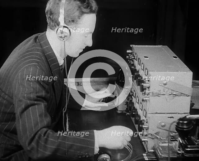 A Man Operating a Radio, 1940. Creator: British Pathe Ltd.