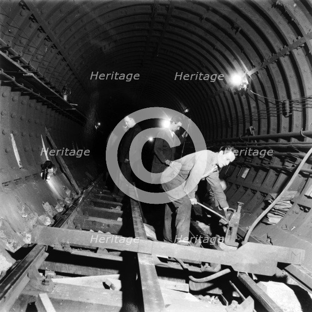 Repairing underground train tracks, London, 1955. Artist: Henry Grant