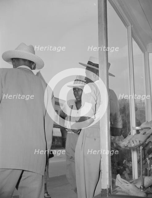 Saturday afternoon, 7th Street and Florida Avenue, N.W., Washington, D.C., 1942. Creator: Gordon Parks.