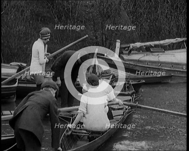 Young Female Civilians Wearing Sport Outfits Climbing Into a Rowing Boat, 1920. Creator: British Pathe Ltd.