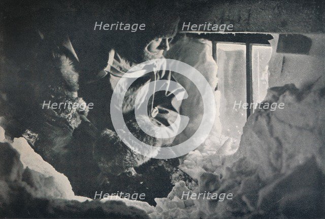 'Clearing Drift from Window of Hut at Cape Adare', c1911, (1913). Artist: G Murray Levick.