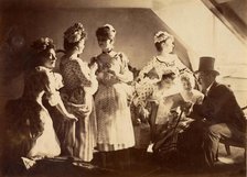 A Group of Six Costumed Women Posed in Interior with Top Hatted Gentlemen, c1885. Creator: Unknown.