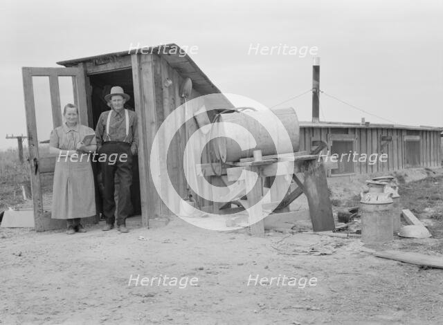 Mr. and Mrs. Wardlow at entrance to their dugout...home, Dead Ox Flat, Malheur County, Oregon, 1939. Creator: Dorothea Lange.