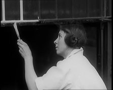 Female Civilian Painting a Building, 1931. Creator: British Pathe Ltd.