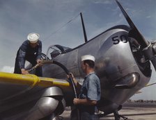 Feeding an SNC advanced training plane its essential supply of gas...Corpus Christi, Texas, 1942. Creator: Howard Hollem.
