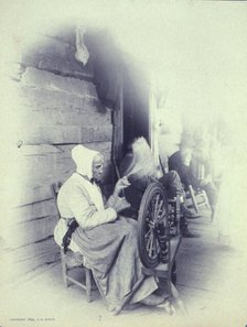 Elderly woman sitting on porch spinning, c1894. Creator: Charles Richards Dodge.