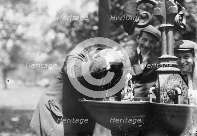 Cooling his head - N.Y. on hot day, between c1910 and c1915. Creator: Bain News Service.