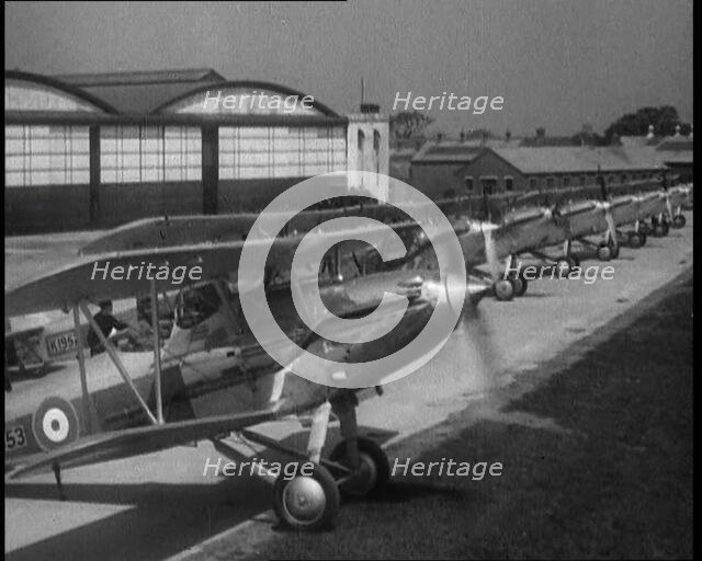 RAF Biplanes Taxiing Across a Field at tended to by Their Aircrews, 1933. Creator: British Pathe Ltd.