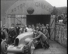 A Crowd of Civilians Watching a Group of Civilians Wheeling Malcolm Campbell's 'Bluebird'..., 1927. Creator: British Pathe Ltd.