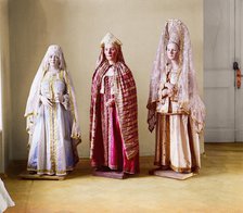 Three mannequins of women in elaborate dress, on wooden stands, between 1905 and 1915. Creator: Sergey Mikhaylovich Prokudin-Gorsky.