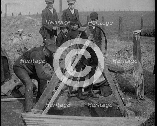Miners Retrieving Coal from a Shallow Surface Mine, 1921. Creator: British Pathe Ltd.