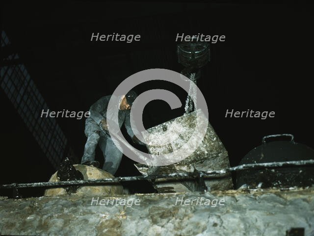 Spreading asbestos mixture on boiler of a locomotive, C & NW RR, 40th Street locomotive shops, 1942. Creator: Jack Delano.