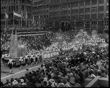 Participants Walking Alongside Floats in a Large Parade During the World Congress for..., 1938. Creator: British Pathe Ltd.