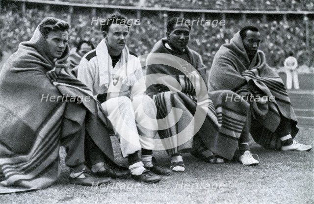Athletes Frank Wykoff, Paul Hanni, Ralph Metcalfe and Jesse Owens, Berlin Olympics, 1936. Artist: Unknown