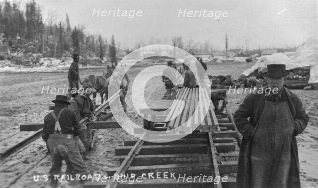 Laying first rails of new U.S. railroad at Ship Creek, between c1900 and c1930. Creator: Unknown.