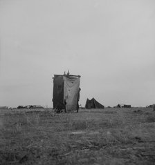 Unsanitary privy in potato pickers' camp near Shafter, California, 1937. Creator: Dorothea Lange.