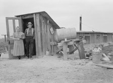 Mr. and Mrs. Wardlow at entrance to their dugout...home, Dead Ox Flat, Malheur County, Oregon, 1939. Creator: Dorothea Lange.