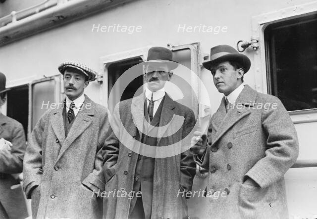 Count de Lesseps, G. Curtiss, and H. Latham standing on train platform, 1910. Creator: Bain News Service.