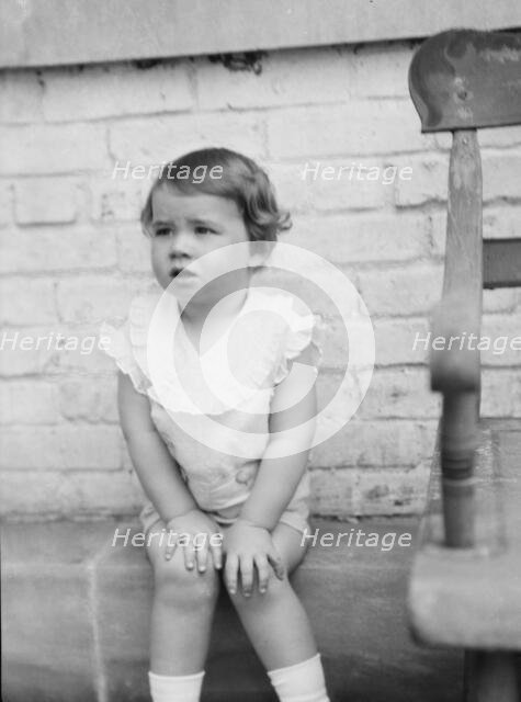 Moseley, F.S., Mr., child of, seated outdoors, 1930 May 24. Creator: Arnold Genthe.