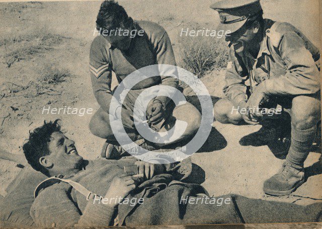 'Ambulance men with a wounded anti-tank gunner', c1942 (1944). Artist: Unknown.