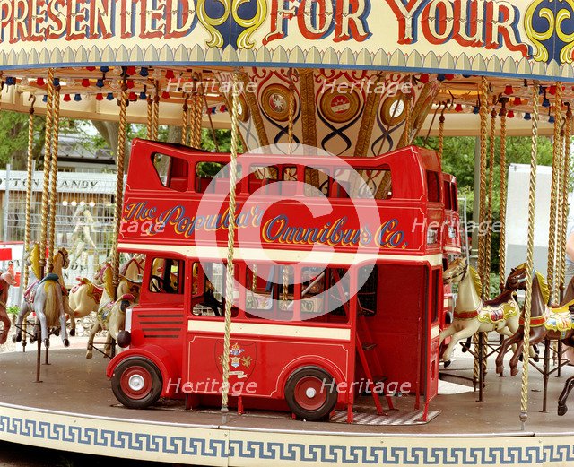 Children's carousel at a funfair in Street, Somerset, c2000.  Artist: M Hesketh-Roberts