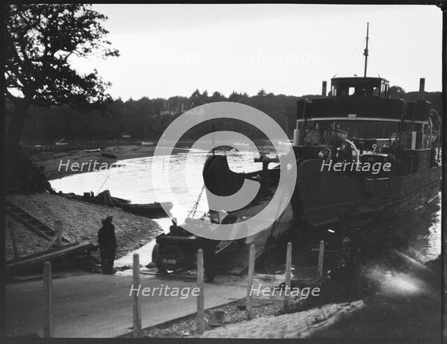 Car driving off the slipway on to the Isle of Wight Ferry at Fishbourne, Isle Of Wight, 1925-35. Creator: George R Long.