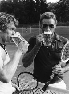 Charlton Heston and Sepp Maier have a beer after playing tennis, Munich, Germany, 1976. Artist: Unknown
