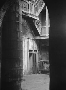Cistern and outer stairs of an old-time courtyard, New Orleans, between 1920 and 1926. Creator: Arnold Genthe.