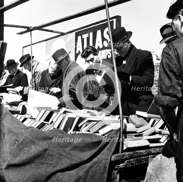Shoppers at a London bookstall, c1950s. Artist: Henry Grant