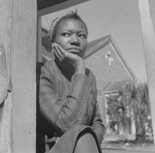 Woman sitting on her porch on Sunday morning, Daytona Beach, Florida, 1943. Creator: Gordon Parks.