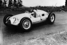 Tazio Nuvolari driving a 3 litre Auto Union in a Grand Prix, 1939. Artist: Unknown