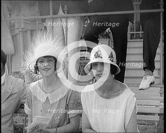 Two Female Civilians at a Horse Race Event Wearing Smart Summer Outfits and Hats, 1920. Creator: British Pathe Ltd.